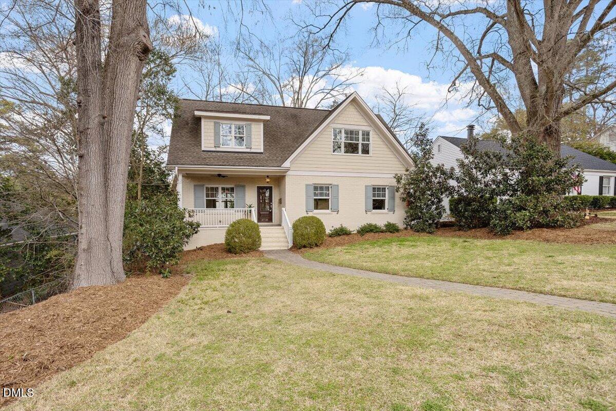2718 Peachtree Street Raleigh, NC 27608 - Photo 2 of 38 a view of a white house next to a yard with large trees