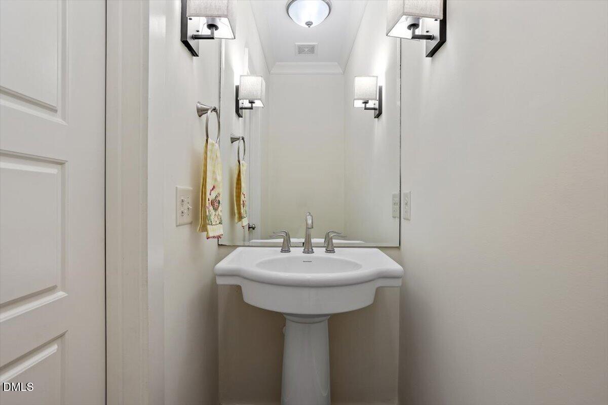 2718 Peachtree Street Raleigh, NC 27608 - Photo 21 of 38 a bathroom with a sink and a mirror