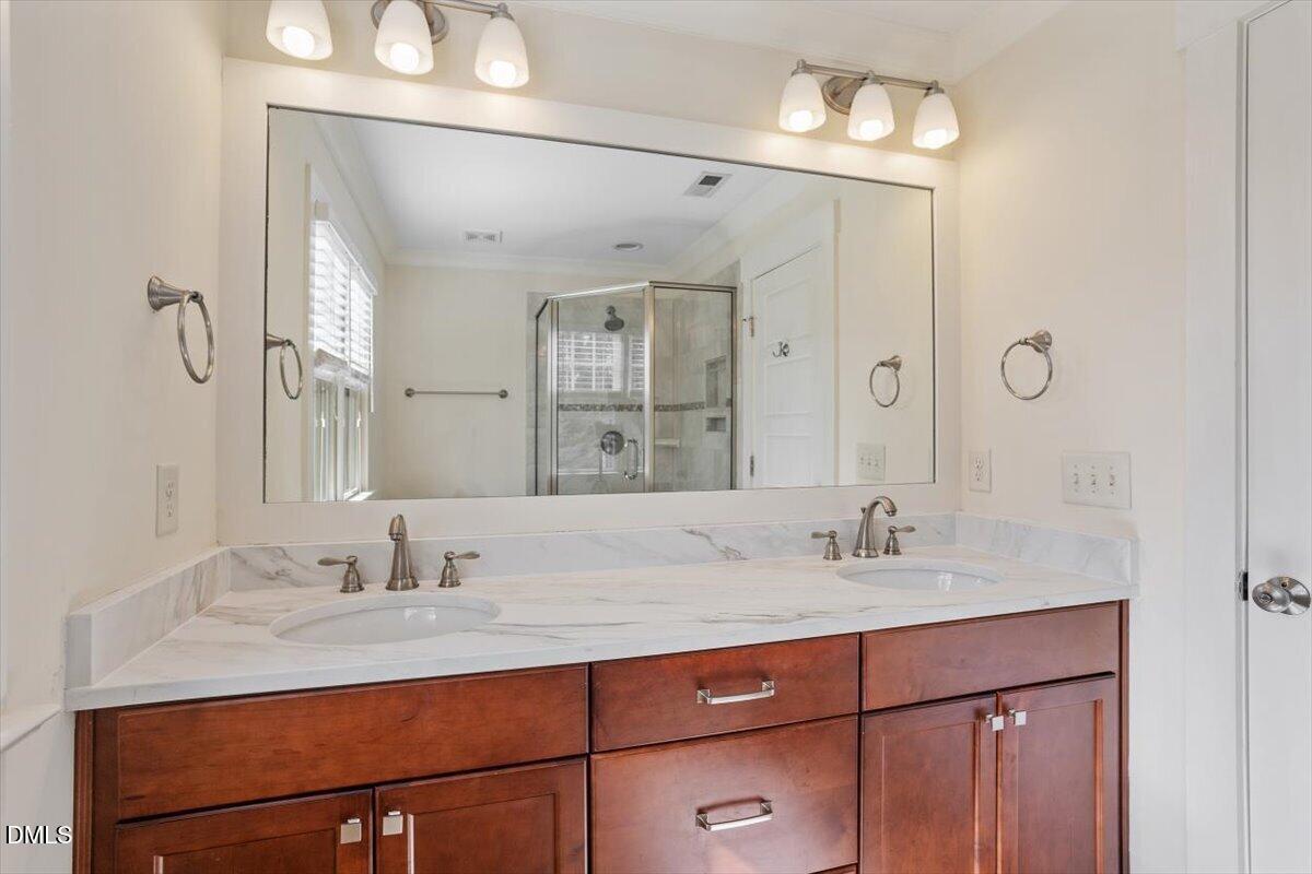 2718 Peachtree Street Raleigh, NC 27608 - Photo 25 of 38 a bathroom with a sink vanity and a mirror