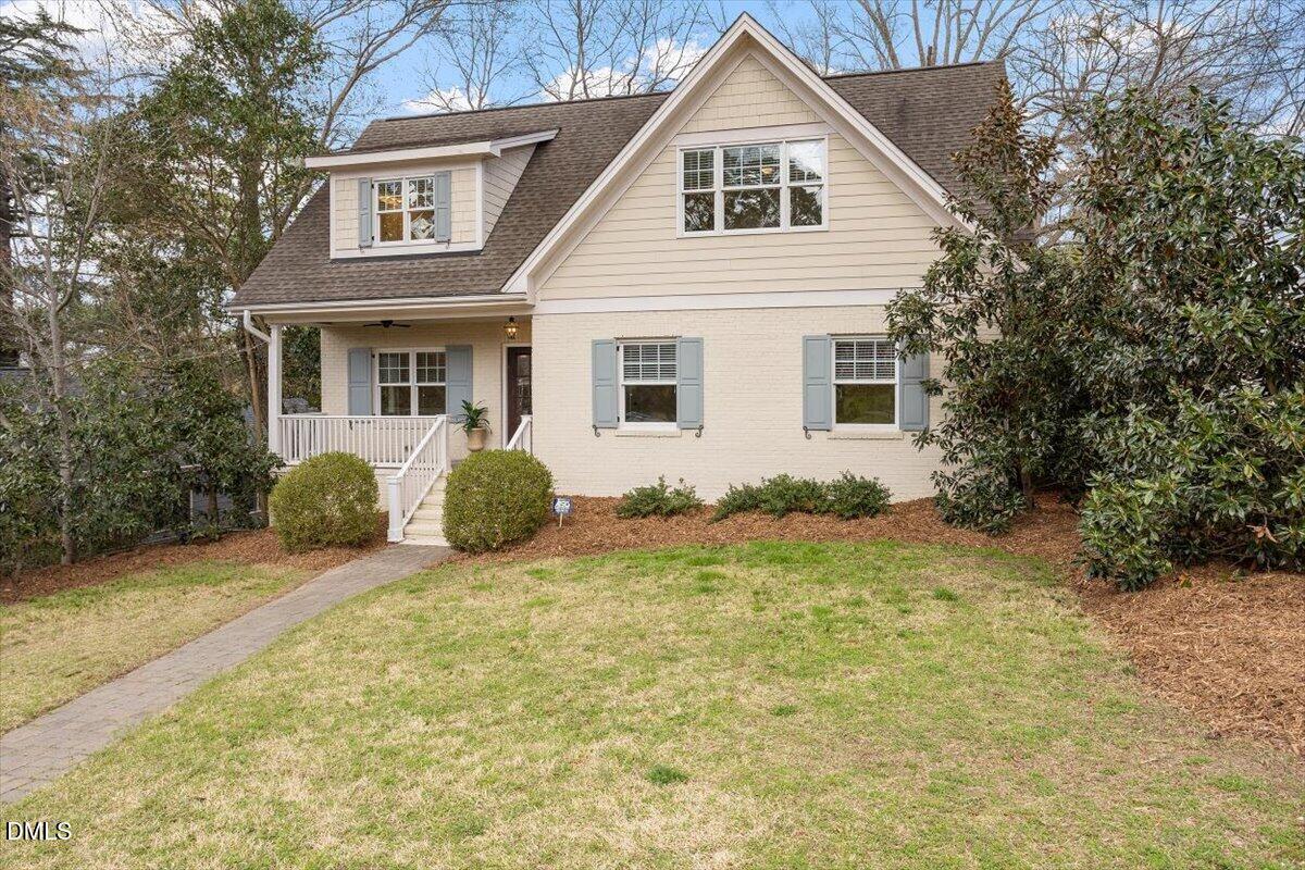 2718 Peachtree Street Raleigh, NC 27608 - Photo 3 of 38 a view of a yard in front of a house with plants and large tree