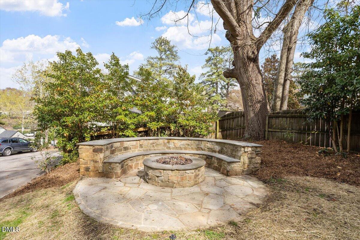 2718 Peachtree Street Raleigh, NC 27608 - Photo 35 of 38 a view of a swimming pool with a yard and large trees