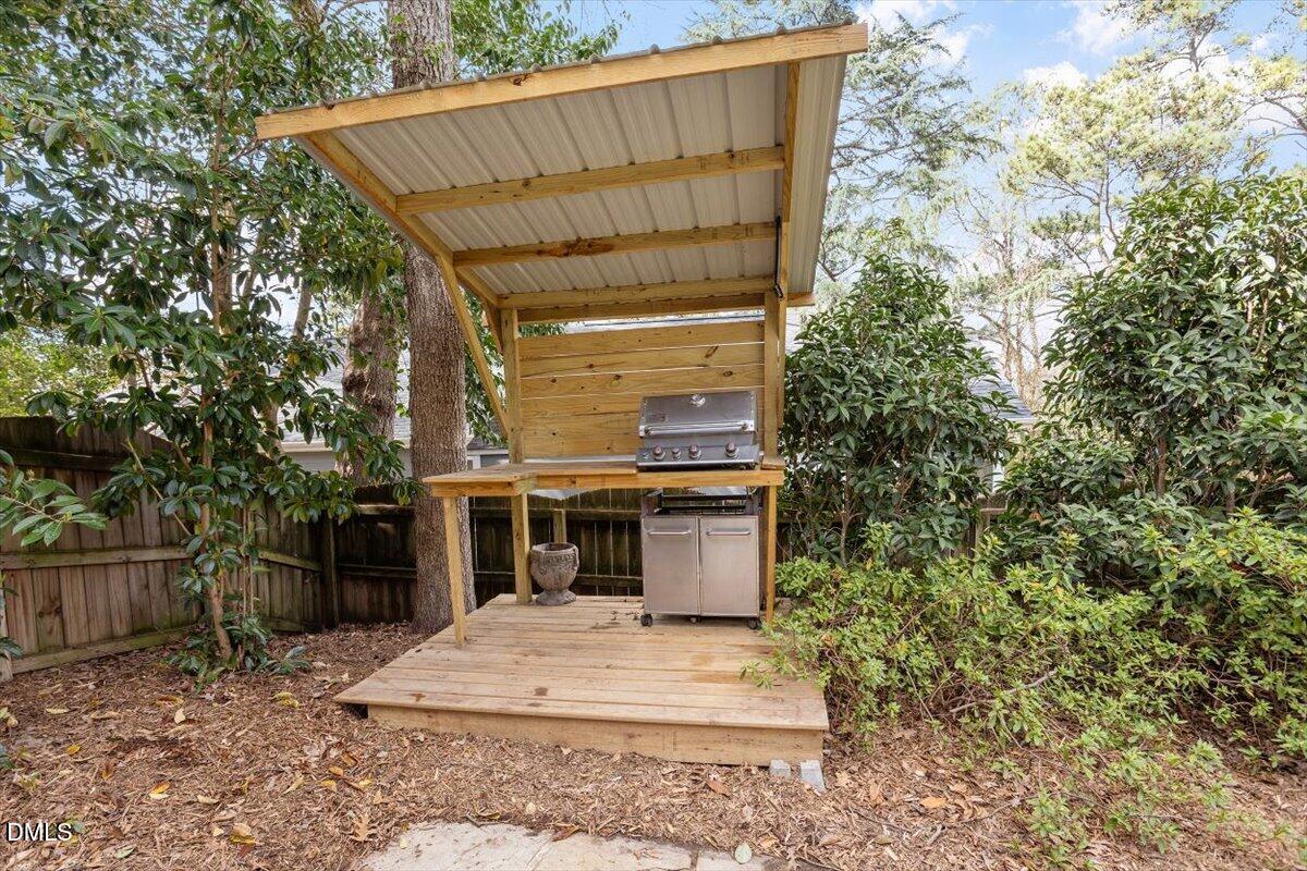 2718 Peachtree Street Raleigh, NC 27608 - Photo 36 of 38 a view of a house with a yard and garage