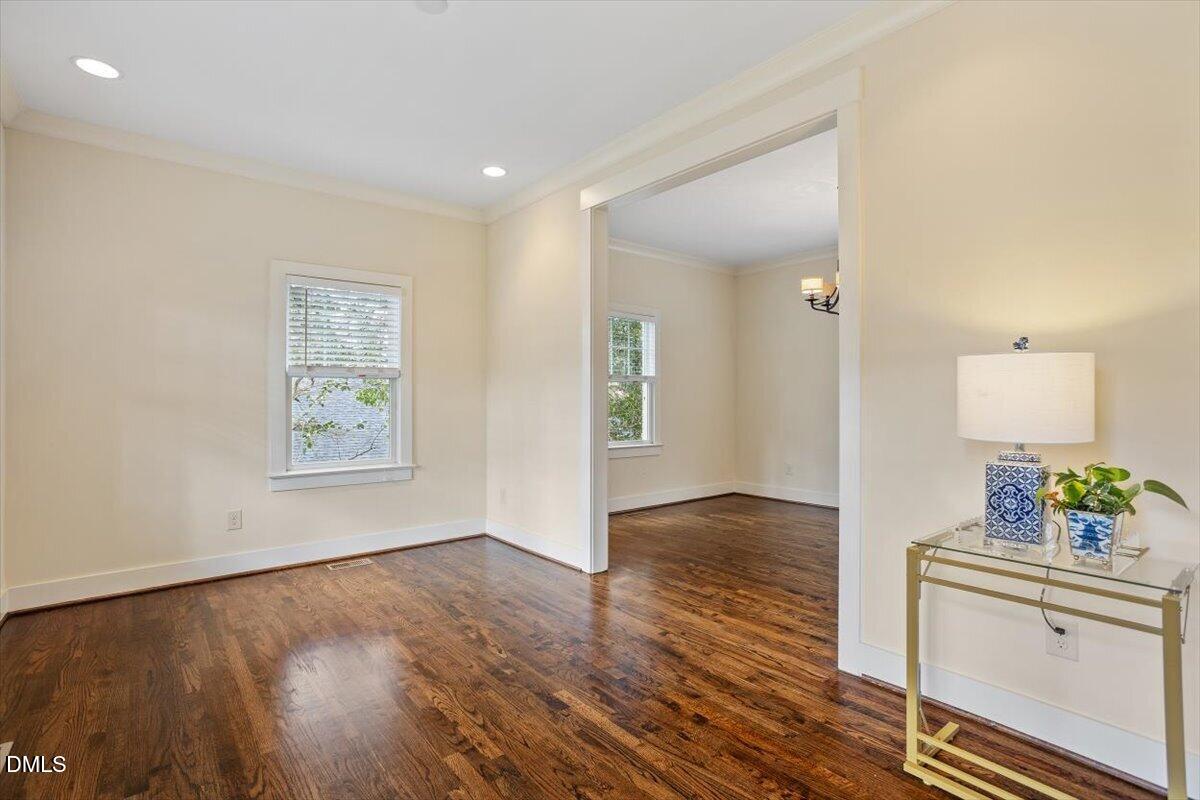 2718 Peachtree Street Raleigh, NC 27608 - Photo 6 of 38 wooden floor in an empty room with a window