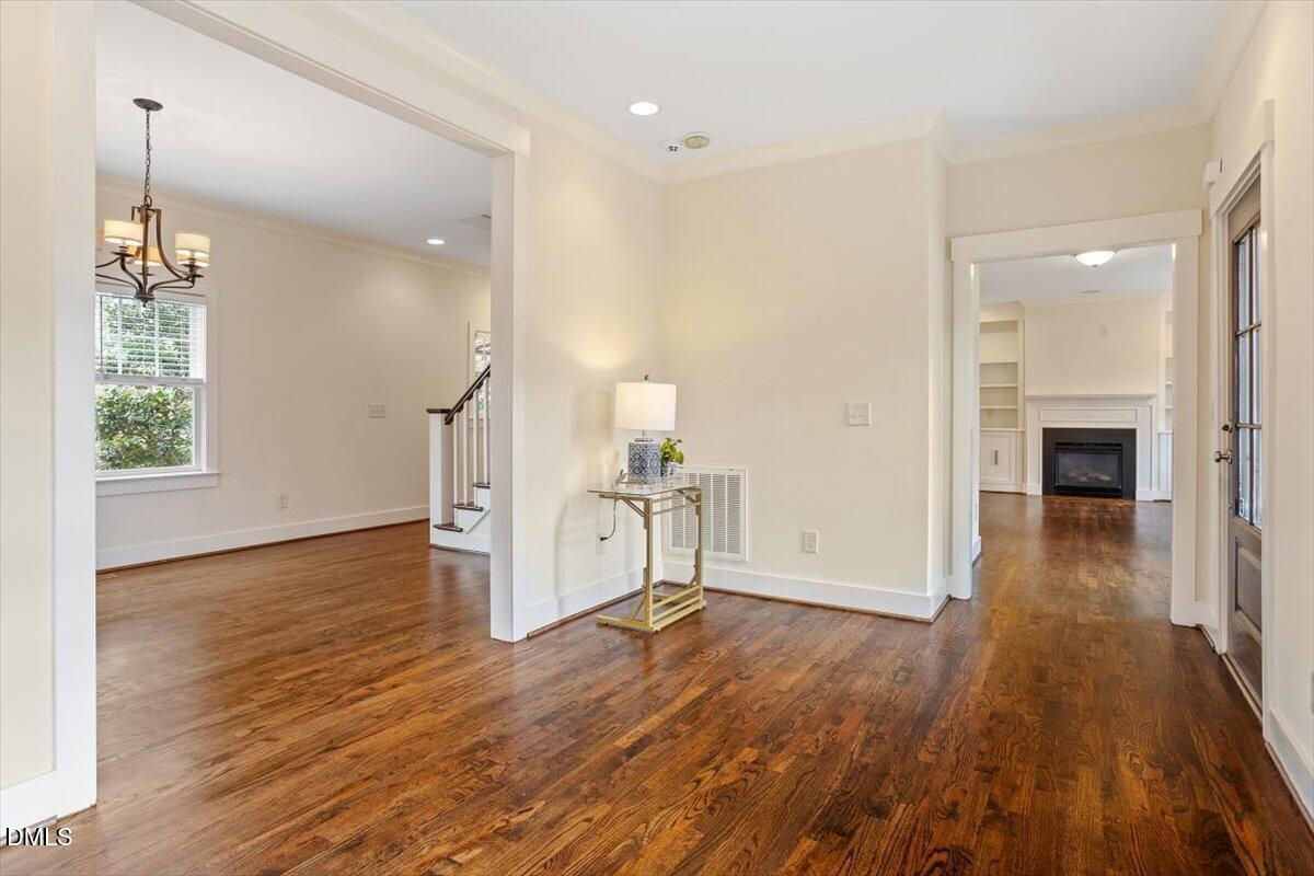 2718 Peachtree Street Raleigh, NC 27608 - Photo 8 of 38 wooden floor in an empty room with a window