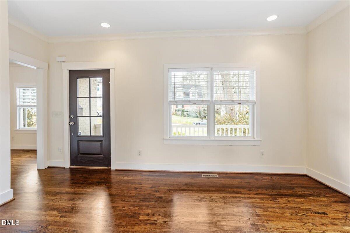 2718 Peachtree Street Raleigh, NC 27608 - Photo 9 of 38 an empty room with wooden floor and windows