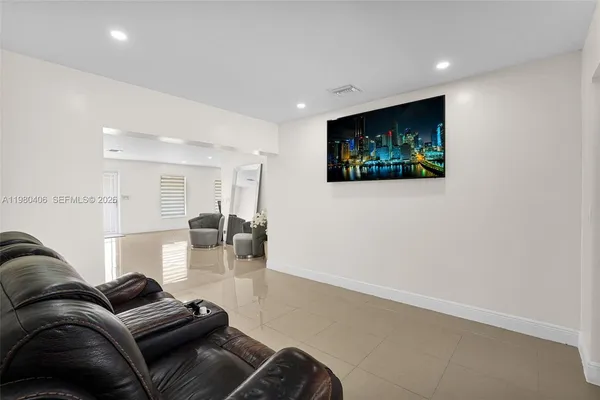 a dining room with furniture and a floor to ceiling window