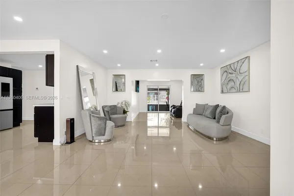 a view of a dining room with furniture and a kitchen