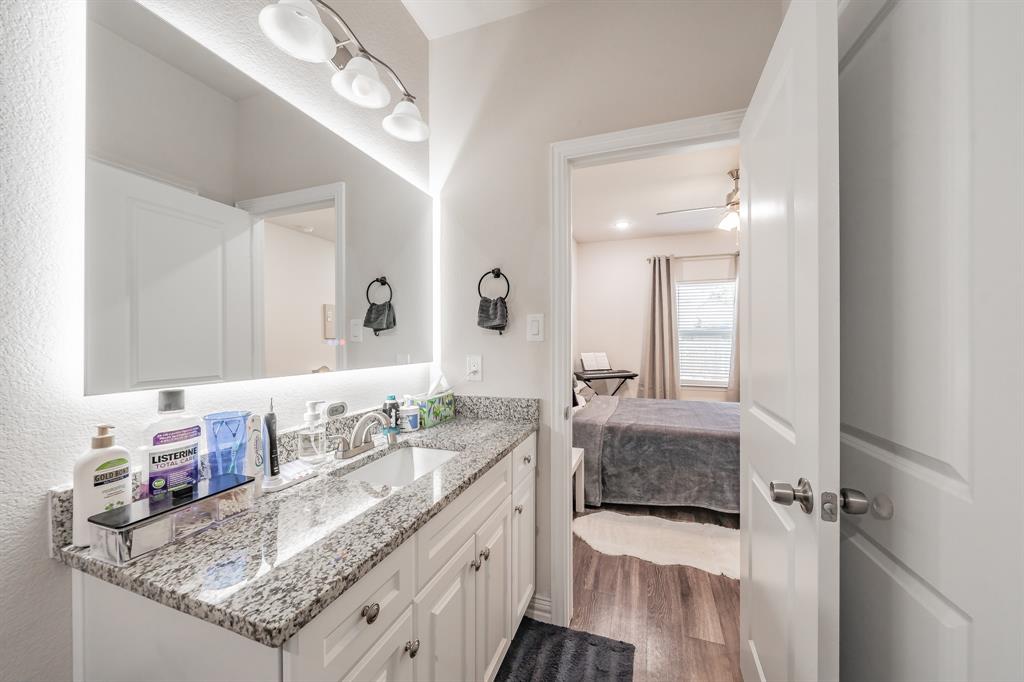 3501 Dillard Street Fort Worth, TX 76105 - Photo 18 of 39 Mater Bathroom featuring granite vanity, decorative lighting.