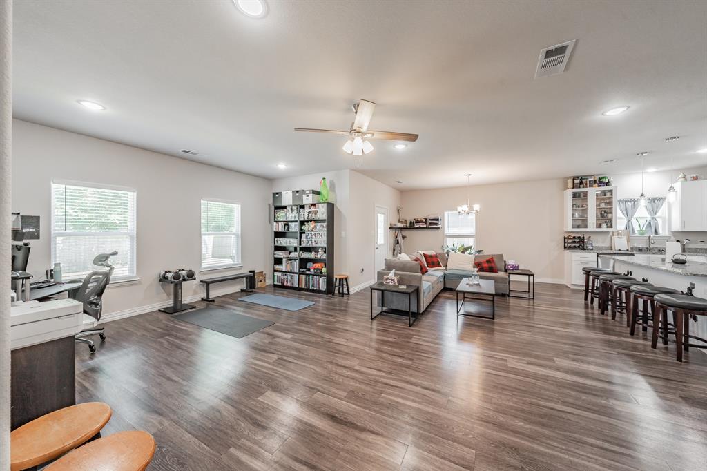 3501 Dillard Street Fort Worth, TX 76105 - Photo 6 of 39 Living room with ceiling fan and large windows to bring natural lighting into the house.