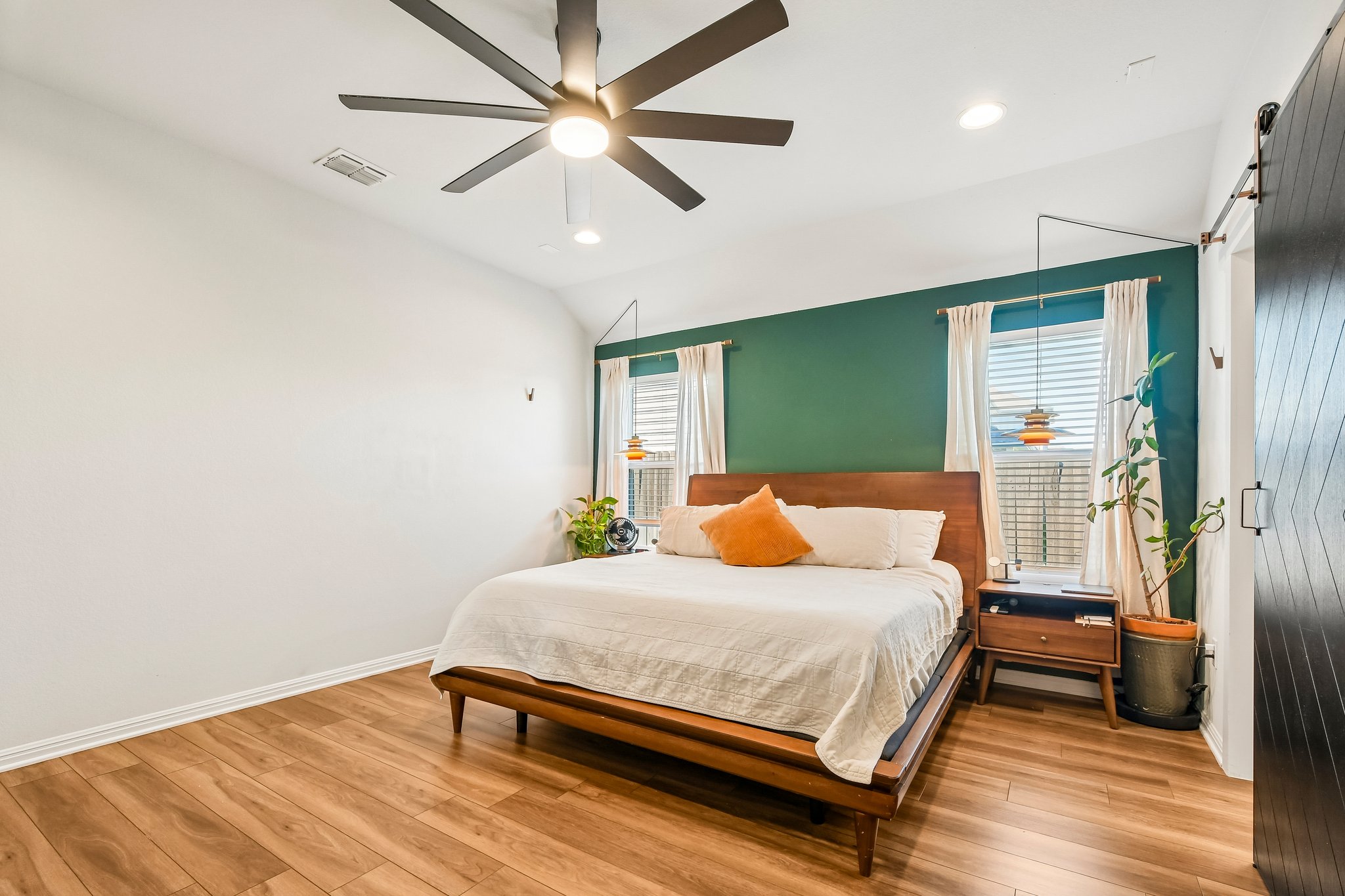 10700 Sentinel Drive Austin, TX 78747 - Photo 15 of 27 The primary features it's own ensuite closed off by a modern, sliding barn door.