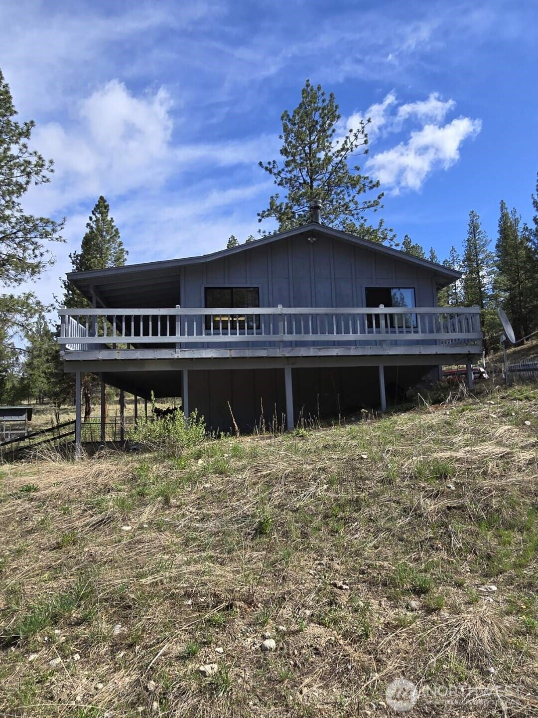 117 Squirrel Road Tonasket, WA 98855 - Photo 2 of 24 a house with river in front of it