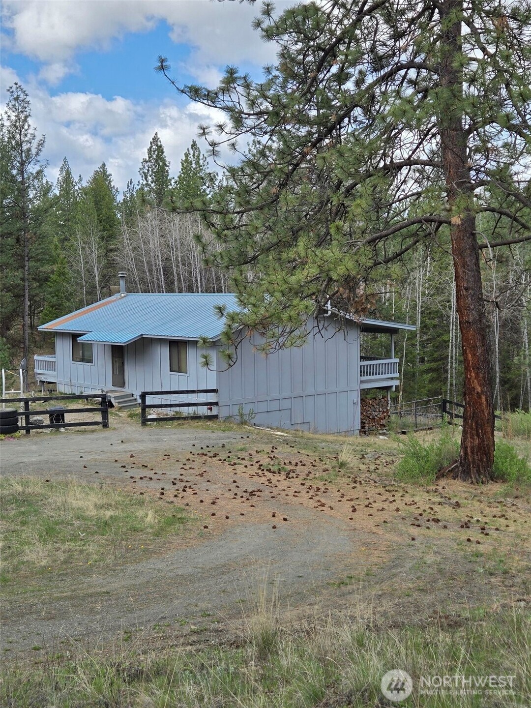 117 Squirrel Road Tonasket, WA 98855 - Photo 3 of 24 a house with trees in the background