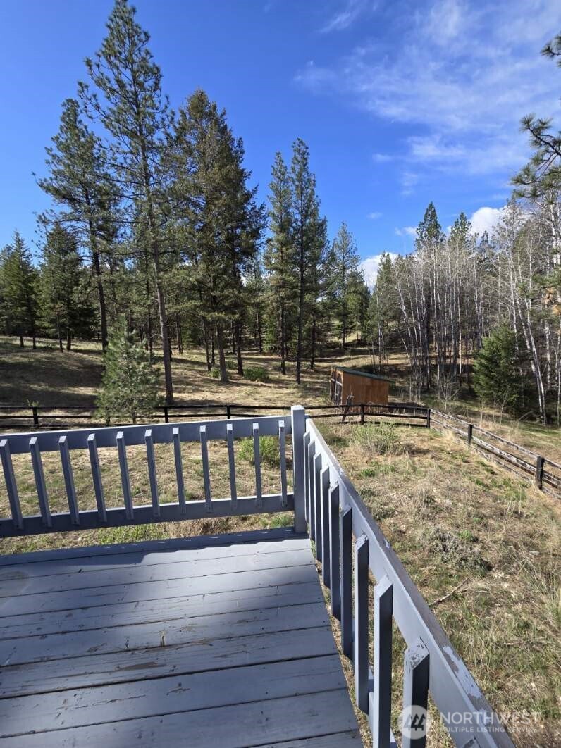 117 Squirrel Road Tonasket, WA 98855 - Photo 8 of 24 a balcony with wooden floor and city view