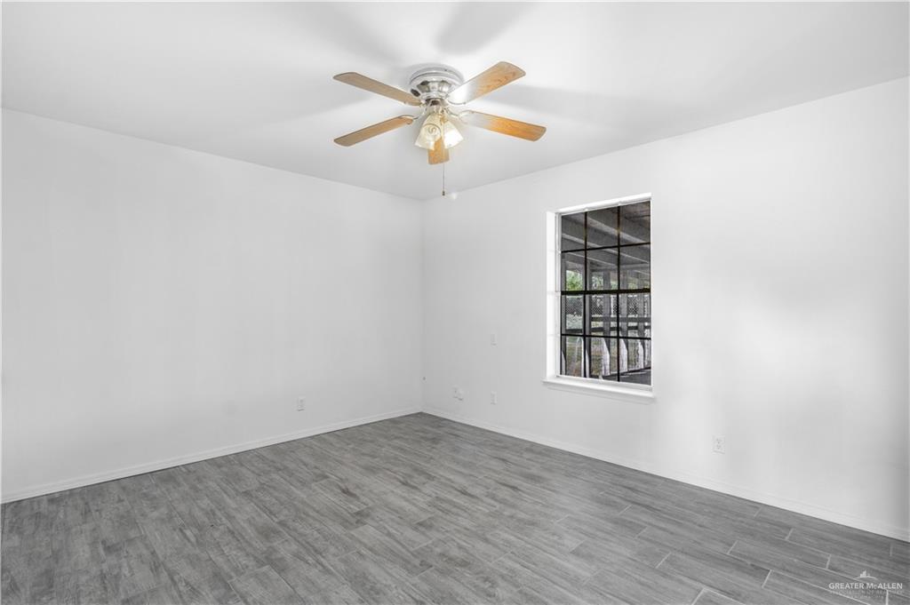 2311 Frontier Drive Palmview, TX 78574 - Photo 11 of 13 wooden floor in an empty room with a window