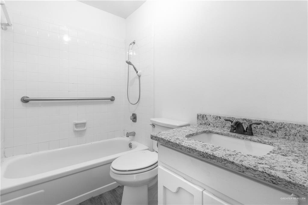 2311 Frontier Drive Palmview, TX 78574 - Photo 12 of 13 a bathroom with a granite countertop sink toilet and shower