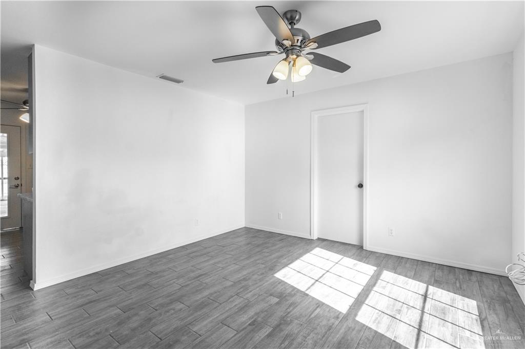 2311 Frontier Drive Palmview, TX 78574 - Photo 4 of 13 an empty room with wooden floor and windows