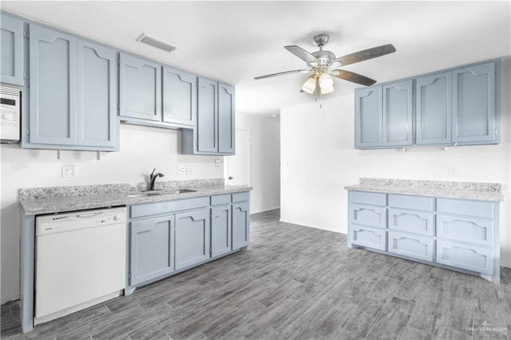 2311 Frontier Drive Palmview, TX 78574 - Photo 6 of 13 a kitchen with granite countertop a sink cabinets stainless steel appliances and a window