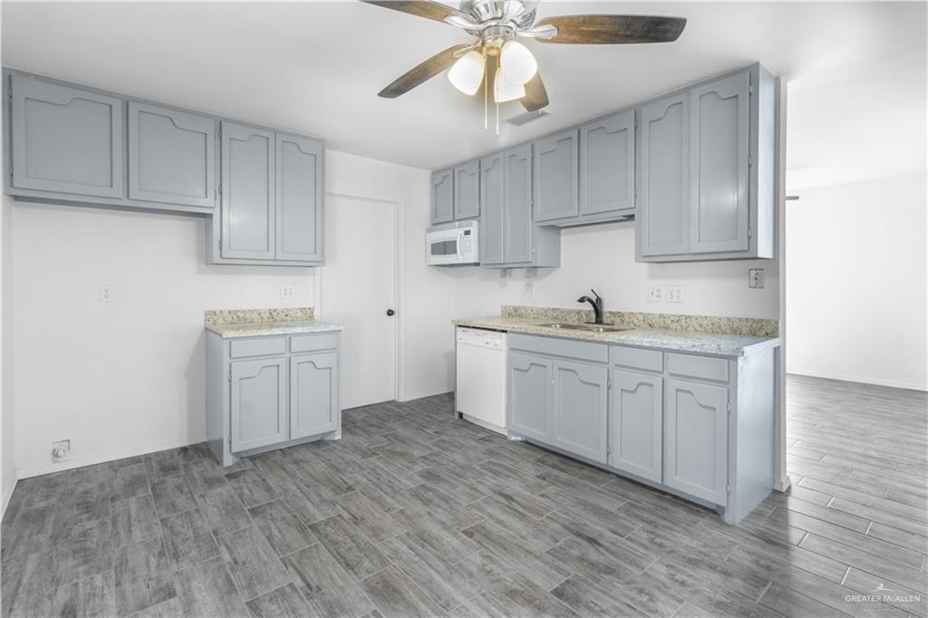 2311 Frontier Drive Palmview, TX 78574 - Photo 7 of 13 a kitchen with a sink cabinets and wooden floor