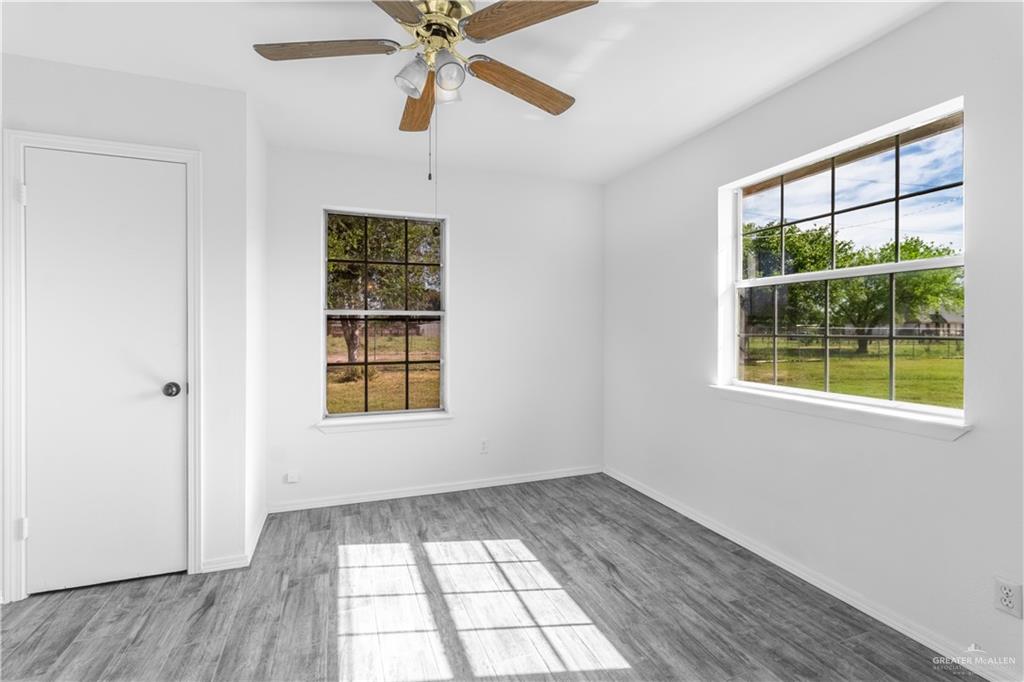 2311 Frontier Drive Palmview, TX 78574 - Photo 8 of 13 wooden floor in an empty room with a window