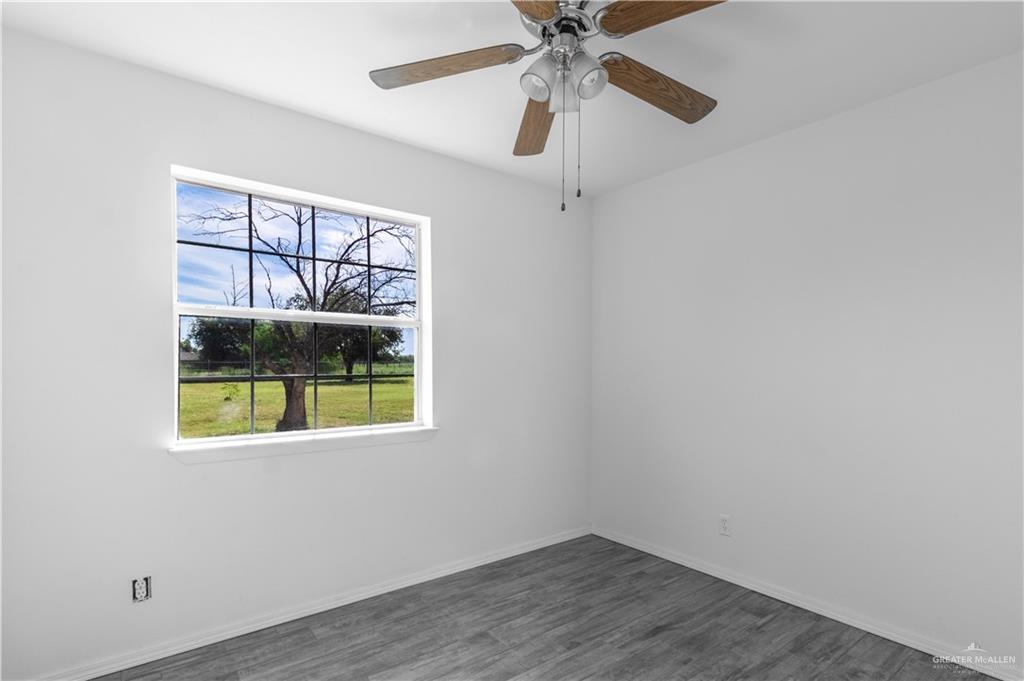 2311 Frontier Drive Palmview, TX 78574 - Photo 10 of 13 an empty room with a window and a fan
