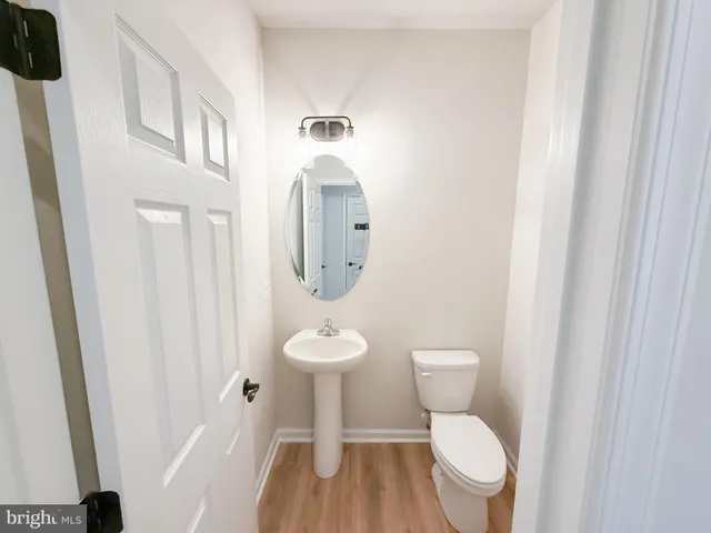 a white toilet sitting next to a bathroom sink