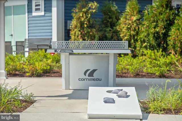 an aerial view of a house with garden space and outdoor seating