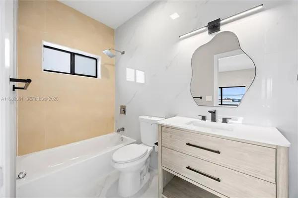 a bathroom with a toilet a sink and a mirror