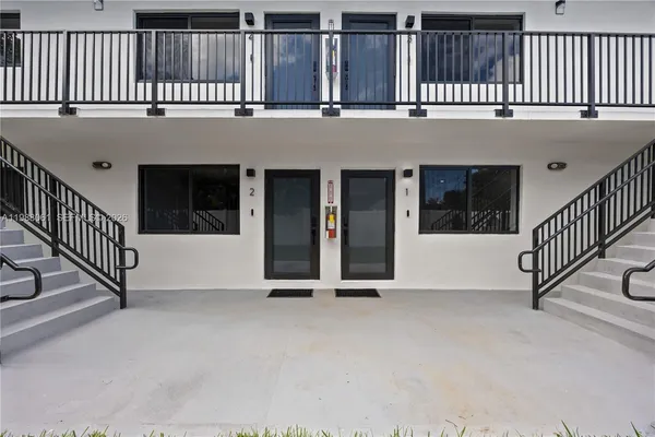 a view of an entryway with a fence