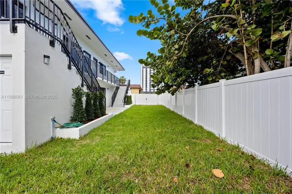 a view of backyard with garden and staircase