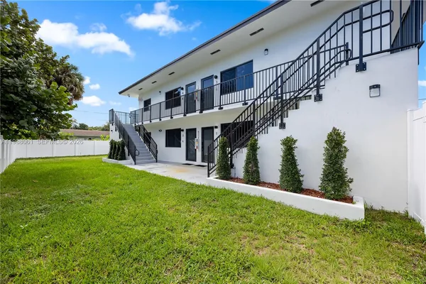 a view of house with swimming pool and sitting area
