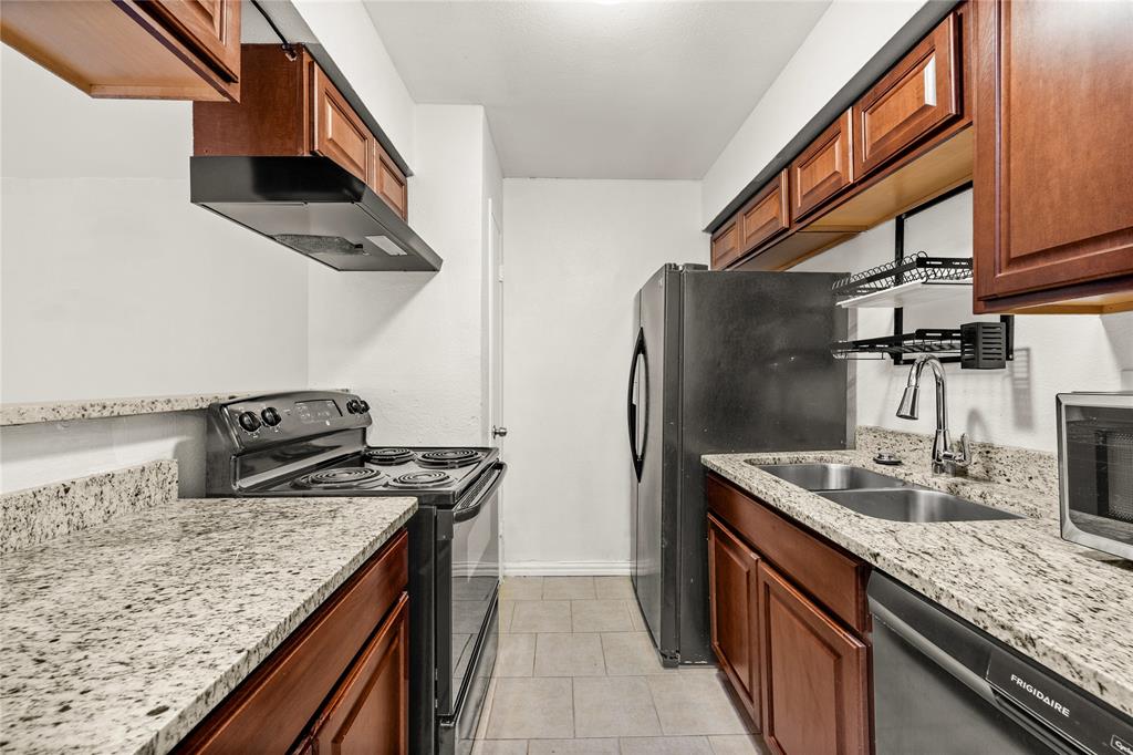8110 Skillman Street, Unit 2053 Dallas, TX 75231 - Photo 1 of 12 a kitchen with stainless steel appliances granite countertop a sink stove and refrigerator