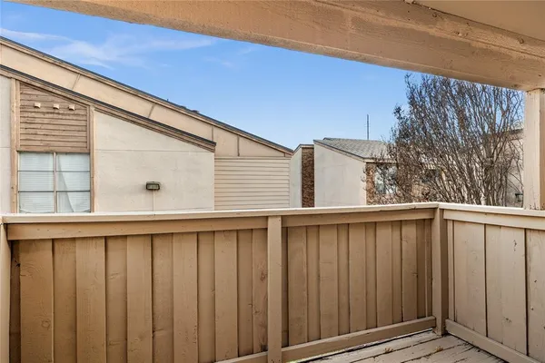 a view of a house with a wooden fence