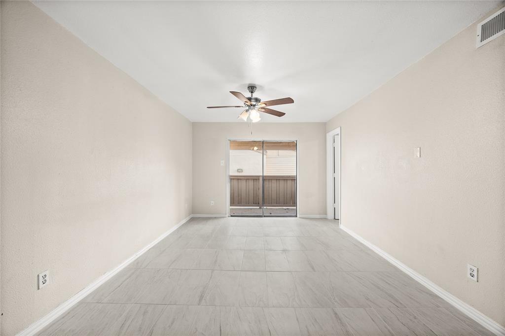 8110 Skillman Street, Unit 2053 Dallas, TX 75231 - Photo 2 of 12 an empty room with fan and windows