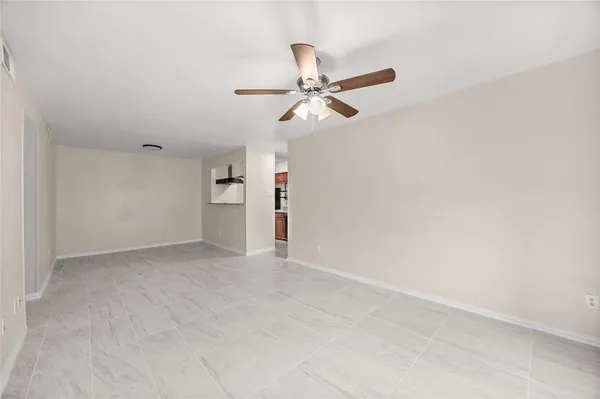 an empty room with closet and windows