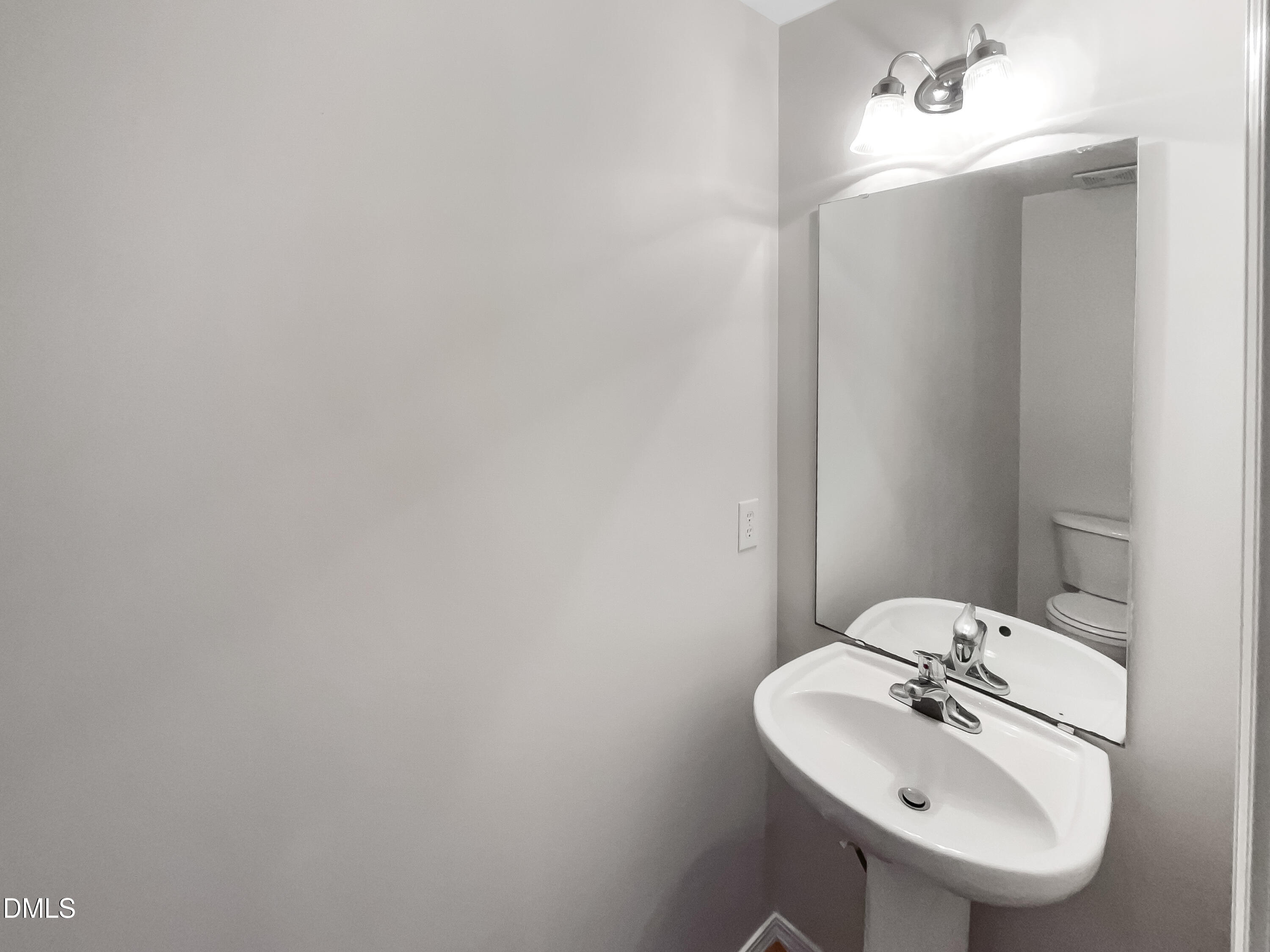 2504 Landale Court Raleigh, NC 27610 - Photo 14 of 16 a bathroom with a sink and a mirror