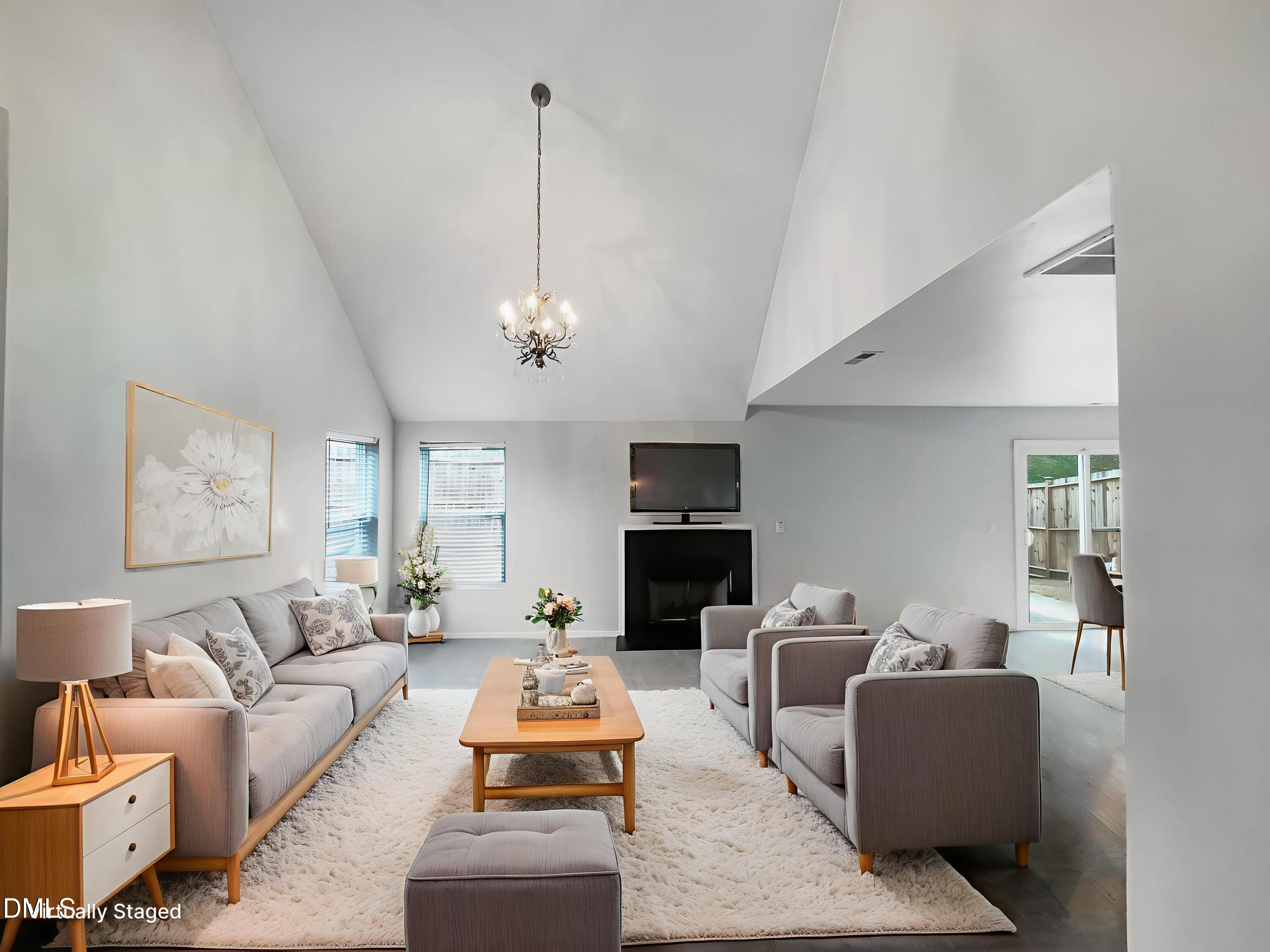 2504 Landale Court Raleigh, NC 27610 - Photo 2 of 16 a living room with furniture a chandelier and a flat screen tv