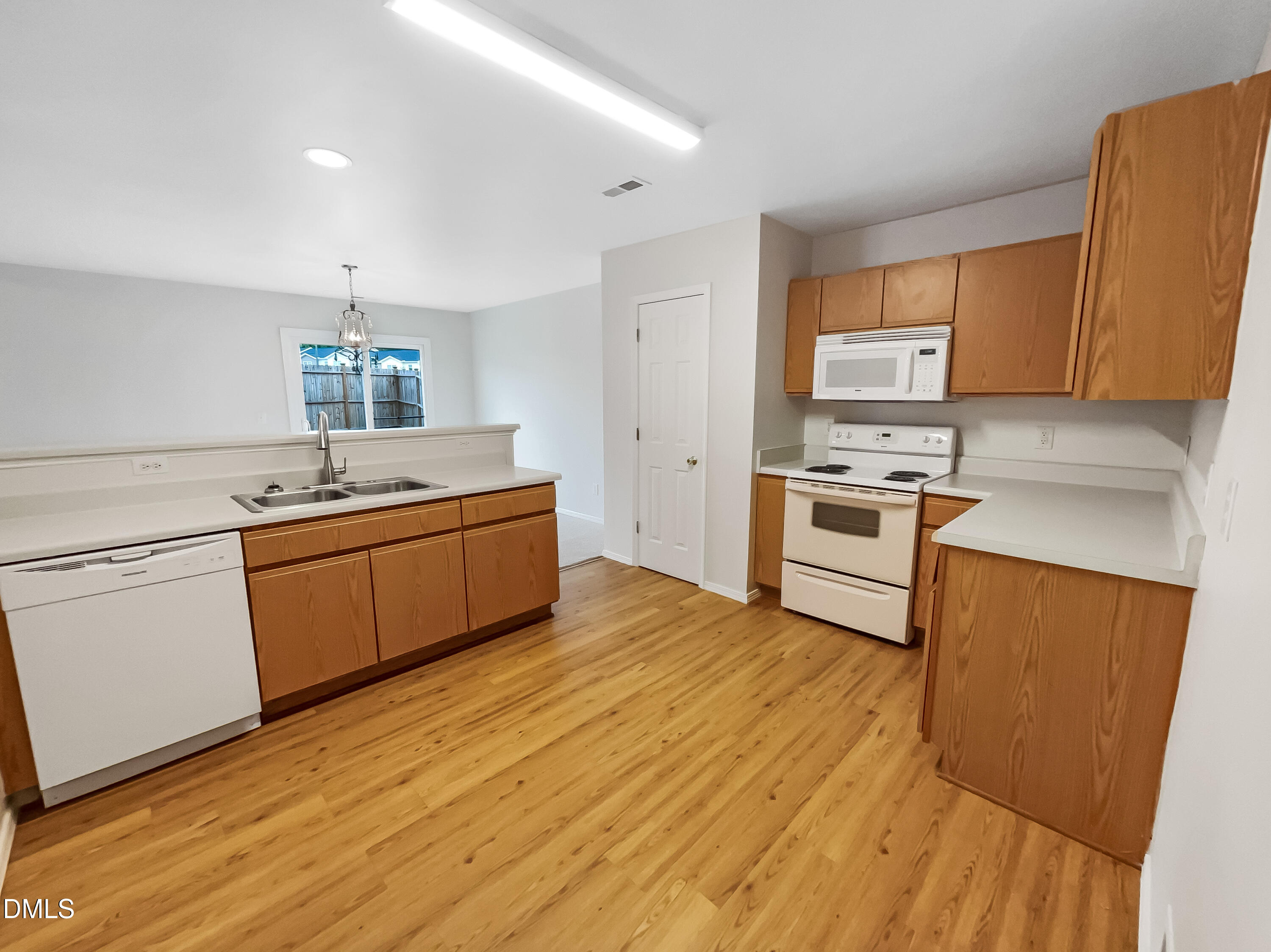 2504 Landale Court Raleigh, NC 27610 - Photo 5 of 16 a kitchen with a sink a stove top oven and wooden floor