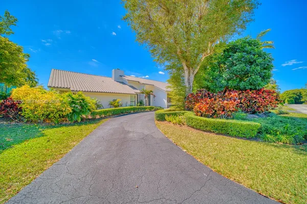 a view of backyard with swimming pool and outdoor seating