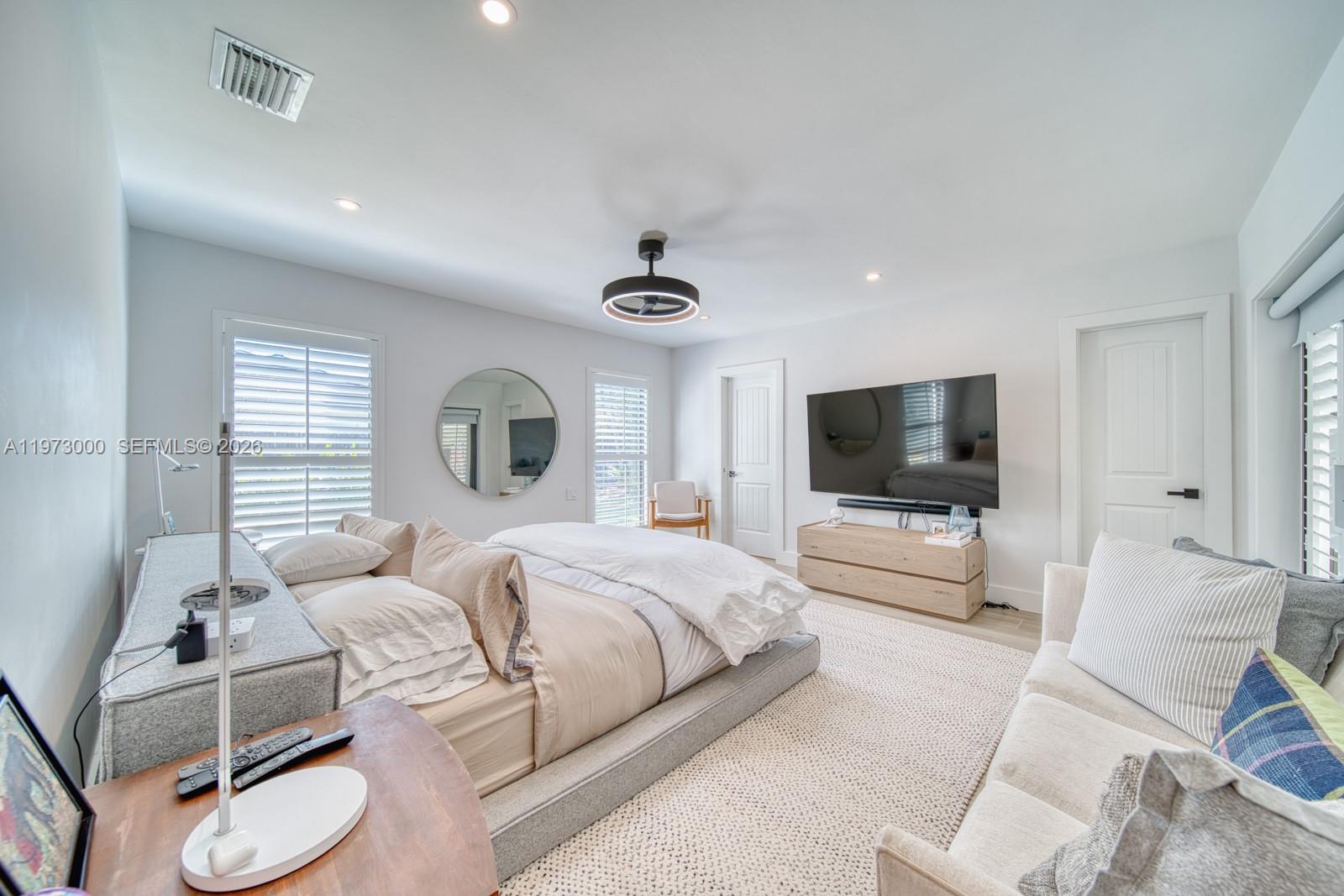 9220 Southwest 102nd Street Miami, FL 33176 - Photo 22 of 53 a bedroom with a bed and a flat screen tv