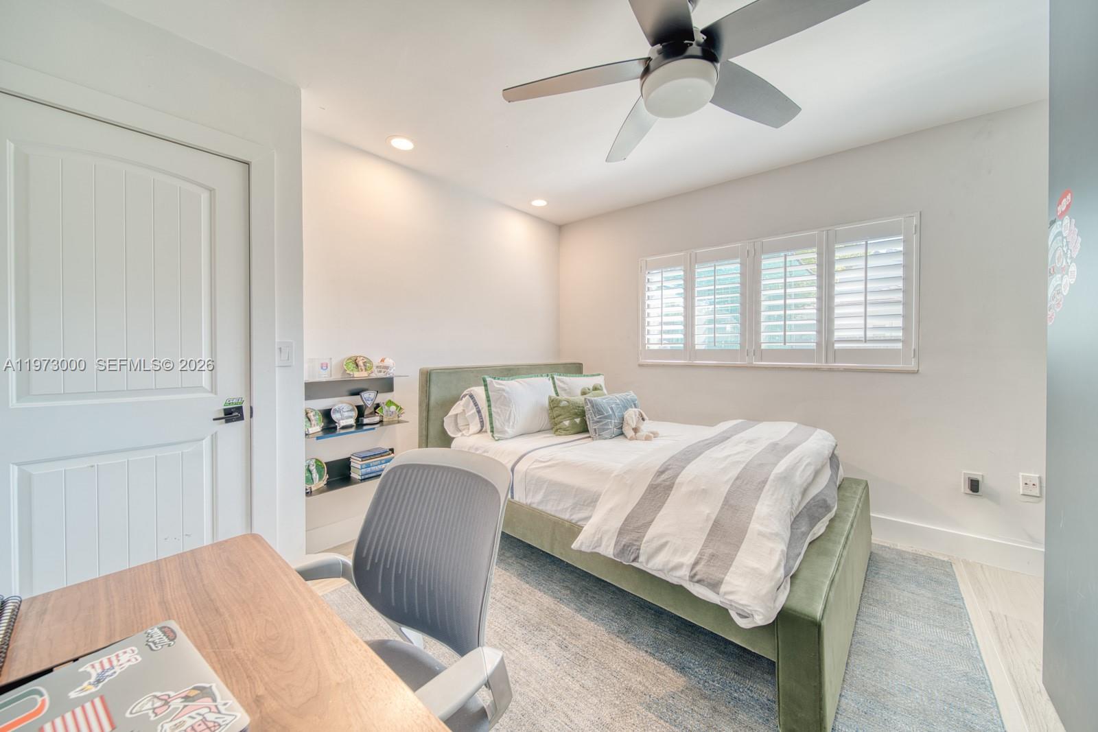 9220 Southwest 102nd Street Miami, FL 33176 - Photo 24 of 53 a bedroom with a large bed and a chandelier fan