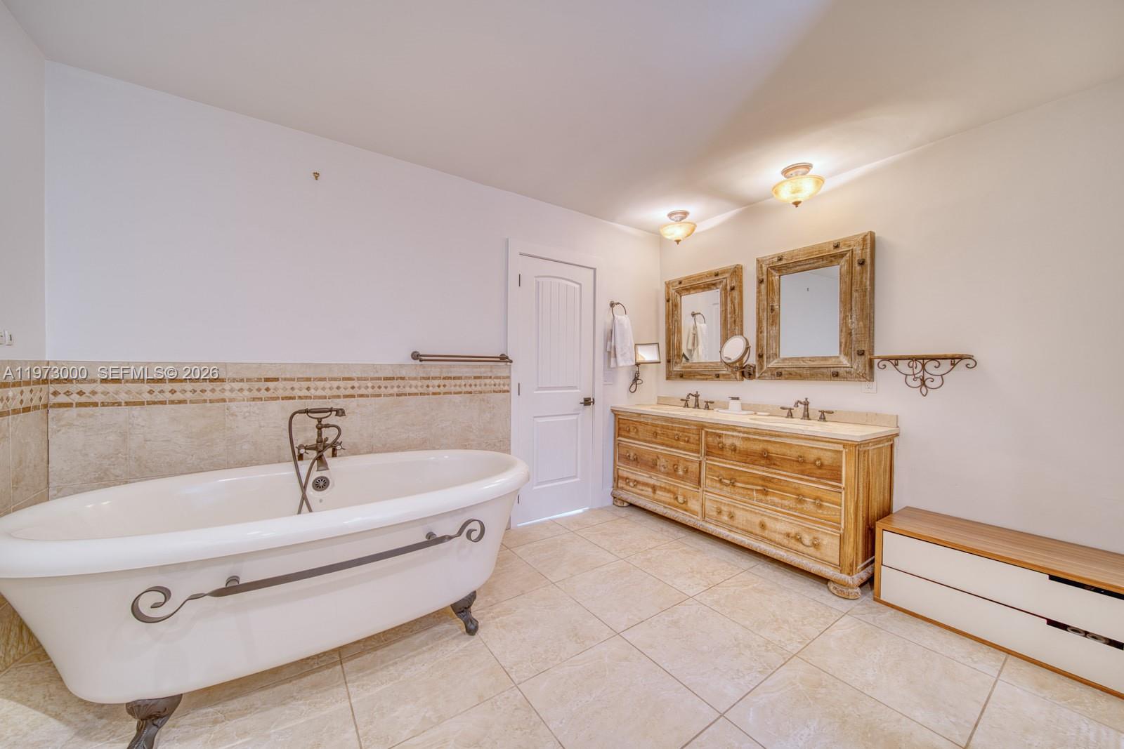 9220 Southwest 102nd Street Miami, FL 33176 - Photo 28 of 53 a spacious bathroom with a tub sink and mirror