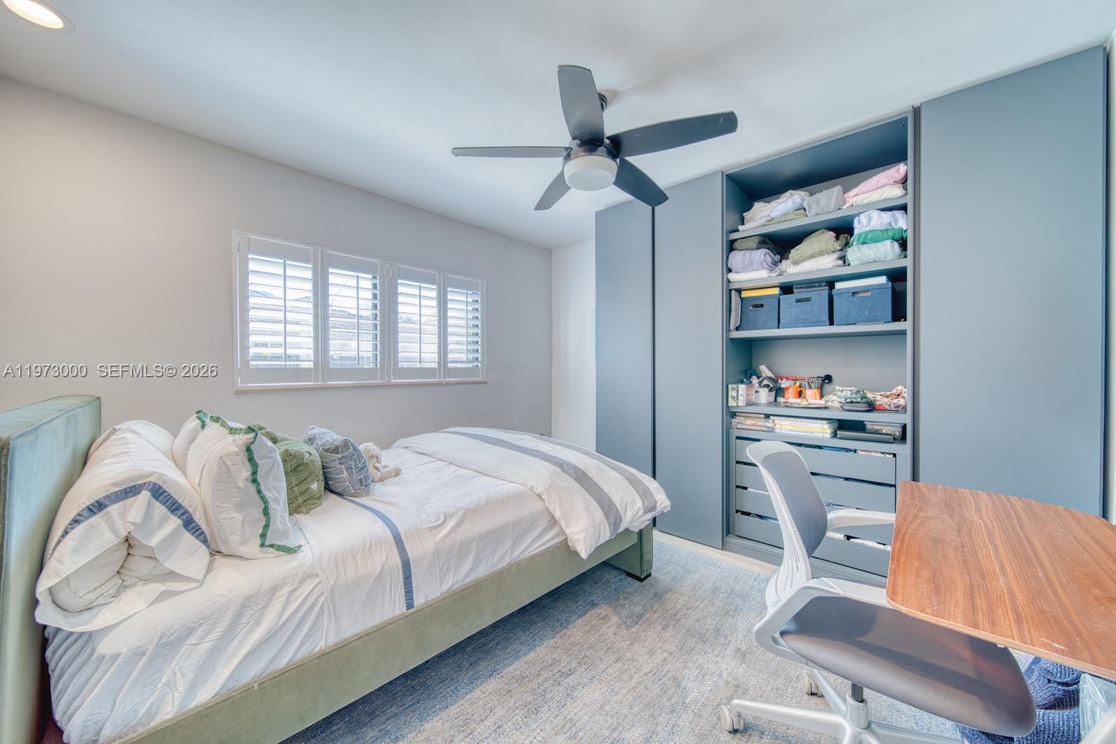 9220 Southwest 102nd Street Miami, FL 33176 - Photo 35 of 53 a bedroom with a bed and a chair with the shoe rack