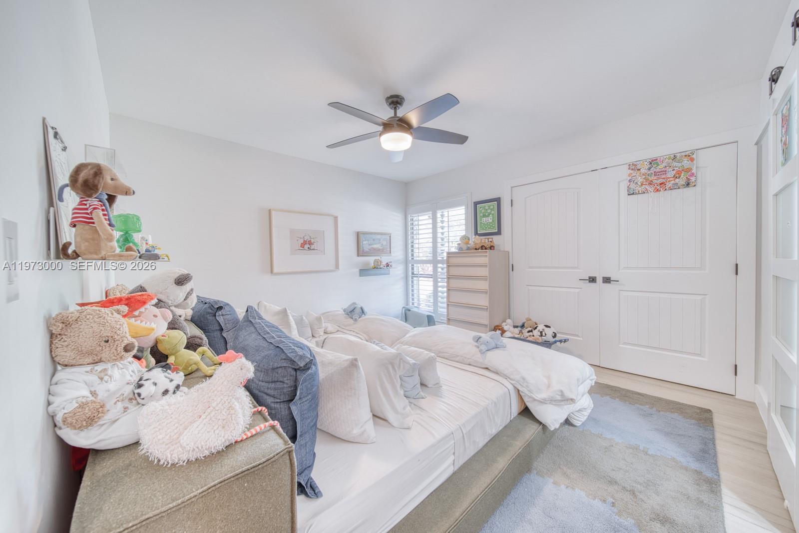 9220 Southwest 102nd Street Miami, FL 33176 - Photo 39 of 53 a bedroom with a bed and a chandelier