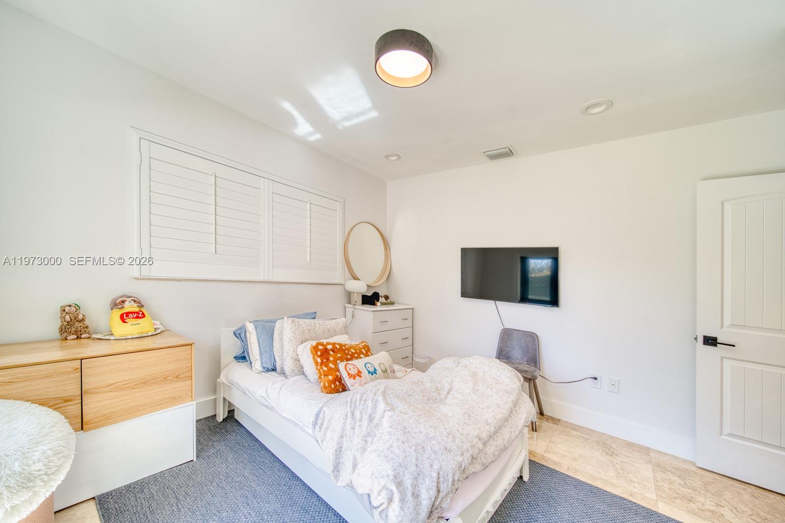 9220 Southwest 102nd Street Miami, FL 33176 - Photo 40 of 53 a bedroom with a bed and a flat screen tv