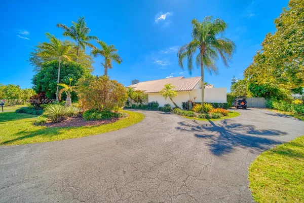 a kitchen with stainless steel appliances kitchen island granite countertop a table and chairs in it