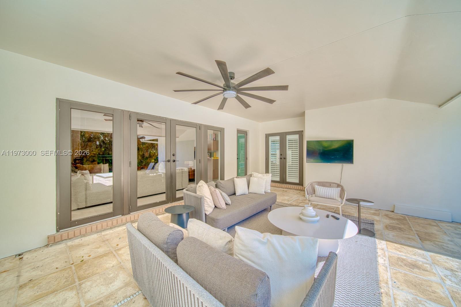 9220 Southwest 102nd Street Miami, FL 33176 - Photo 43 of 53 a living room with couches a flat screen tv and kitchen view