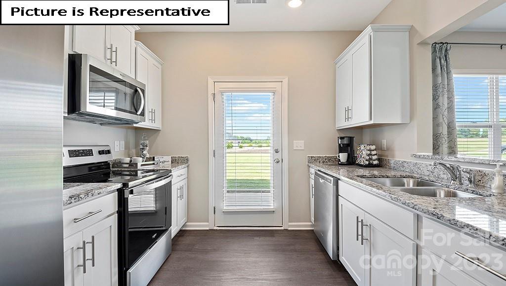 7035 North Mill Road Charlotte, NC 28216 - Photo 11 of 26 a kitchen with stainless steel appliances granite countertop a sink stove and cabinets