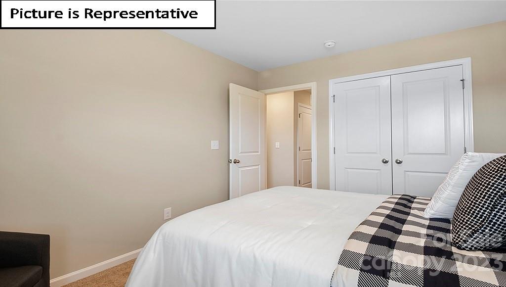 7035 North Mill Road Charlotte, NC 28216 - Photo 22 of 26 a bedroom with a bed and wooden floor