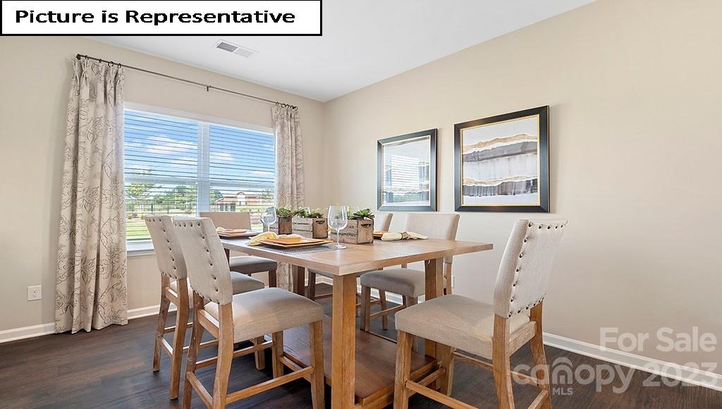 7035 North Mill Road Charlotte, NC 28216 - Photo 7 of 26 a view of a dining room with furniture and wooden floor