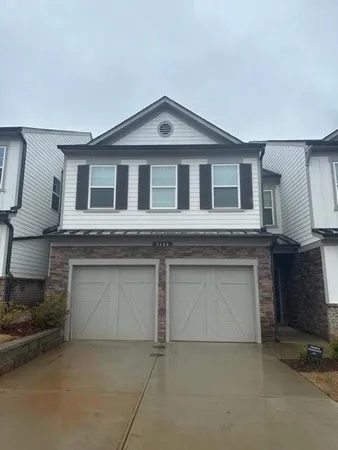 a front view of a house with garage